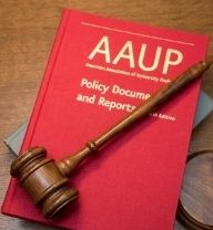 wooden gavel laying across the AAUP's Policy Documents and Reports, a book with a red cover and gold lettering with gray book and wooden desk beneath